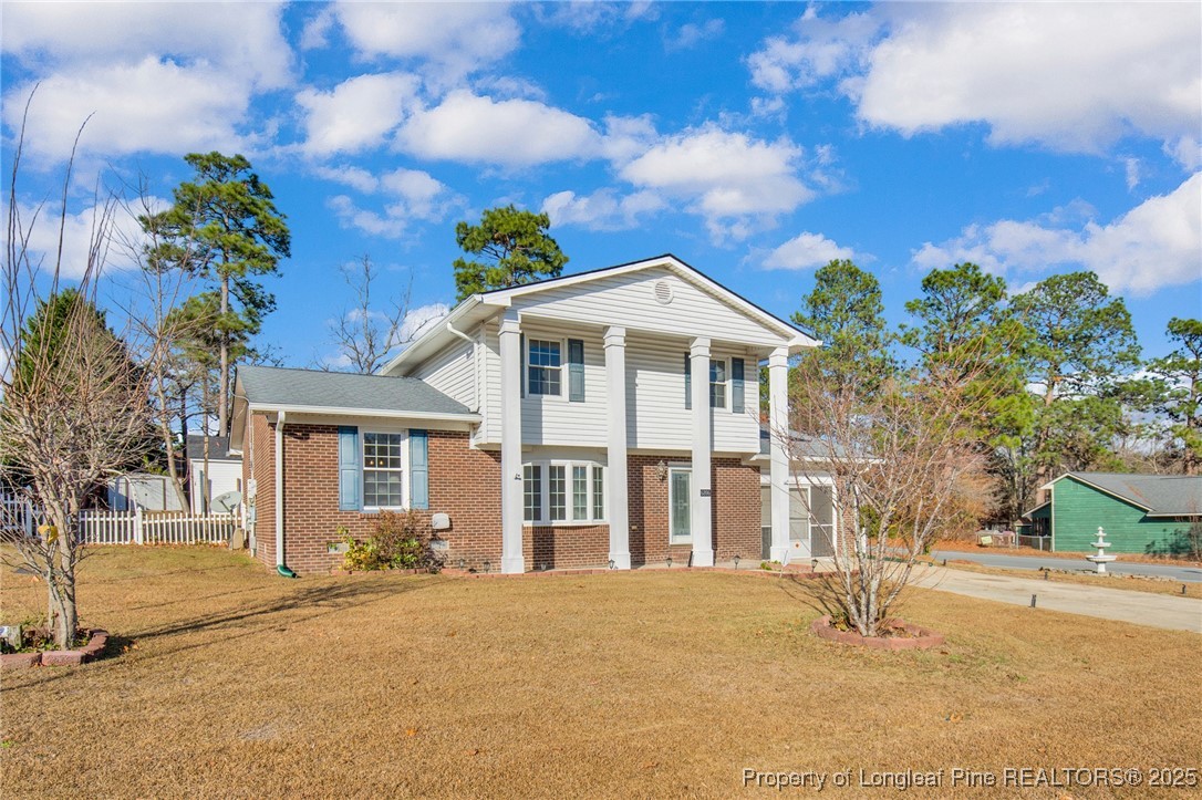 6806 Beaver Stone Road Fayetteville, NC 28314 - Photo 3 of 42 a front view of a house with a yard and garage
