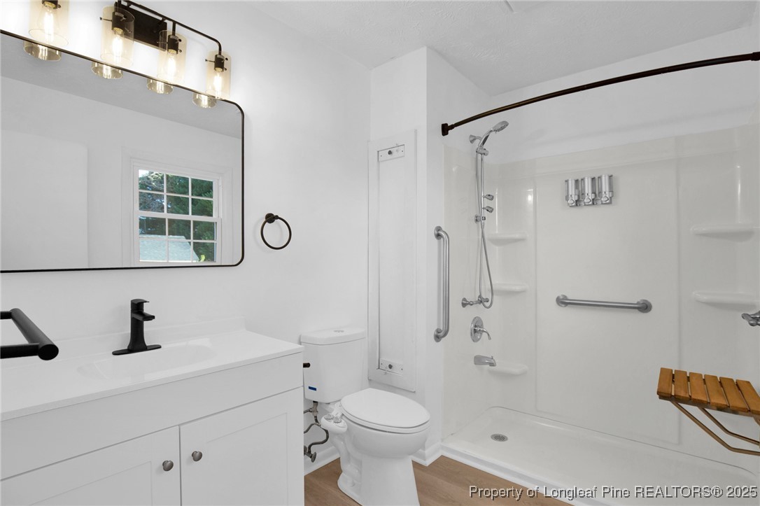 6806 Beaver Stone Road Fayetteville, NC 28314 - Photo 31 of 42 a bathroom with a sink a toilet and shower