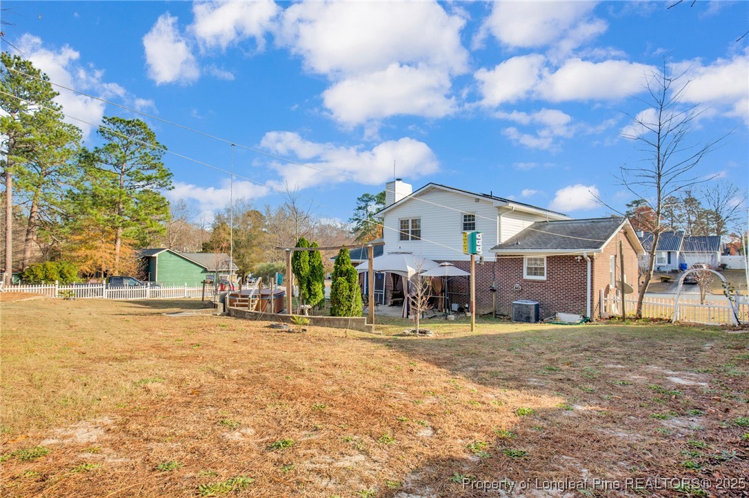 6806 Beaver Stone Road Fayetteville, NC 28314 - Photo 39 of 42 a view of a house with a yard and chair