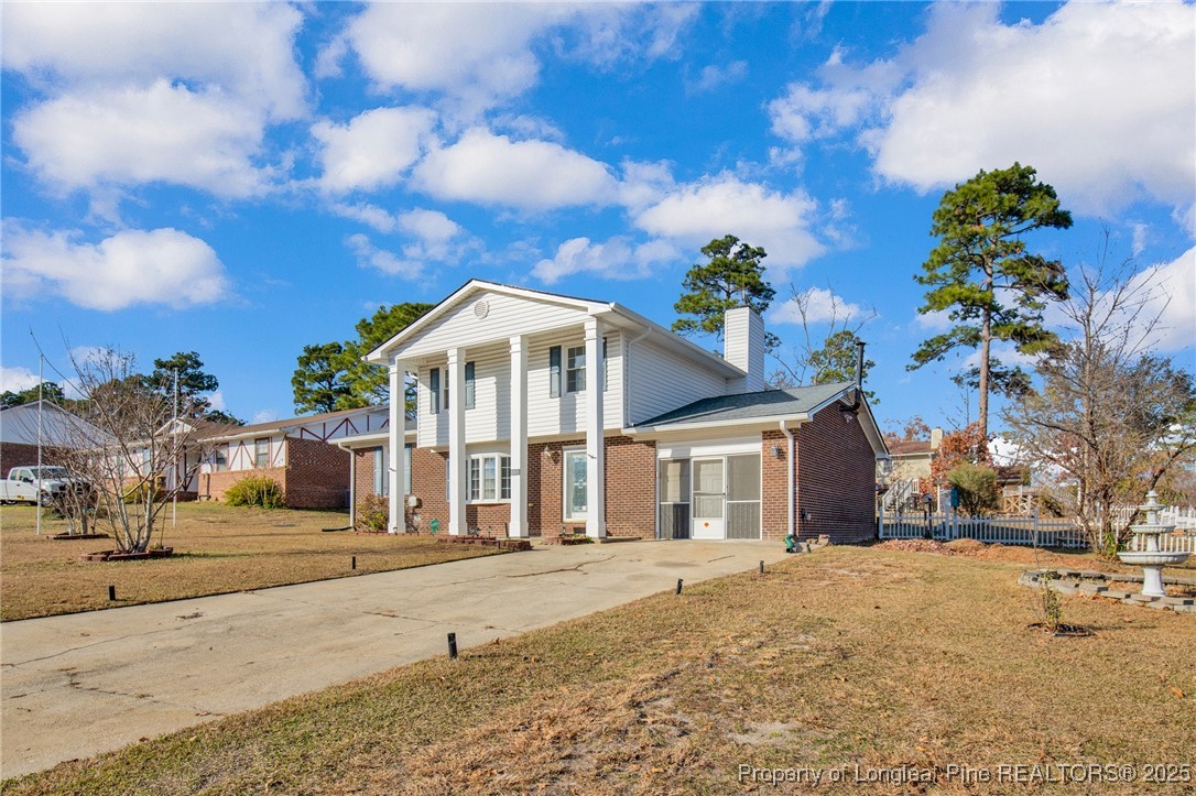 6806 Beaver Stone Road Fayetteville, NC 28314 - Photo 4 of 42 a front view of a house with a garden