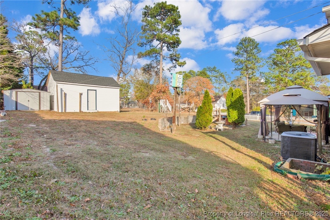 6806 Beaver Stone Road Fayetteville, NC 28314 - Photo 42 of 42 a backyard of a house with table and chairs