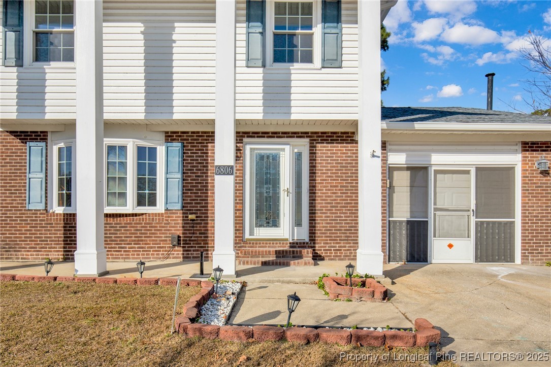 6806 Beaver Stone Road Fayetteville, NC 28314 - Photo 6 of 42 a view of a brick house with many windows