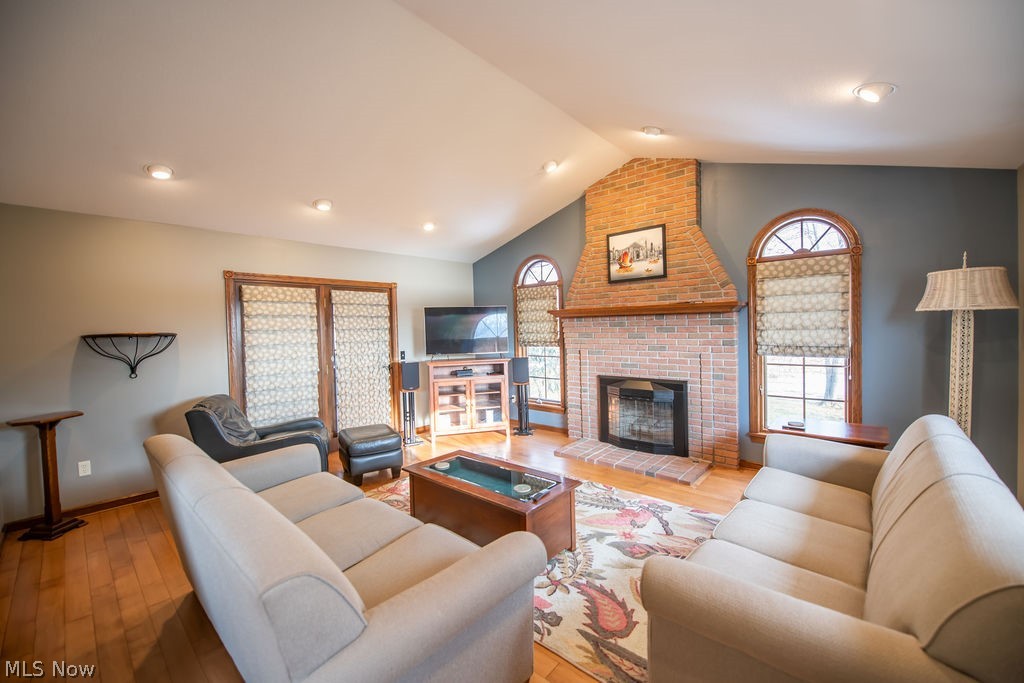 4848 Fette Road Dennison, OH 44621 - Photo 15 of 48 Living room with hardwood floors, plenty of natural light, a brick fireplace, and recessed lighting