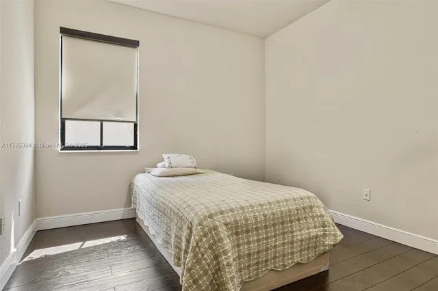 a bedroom with a bed and window