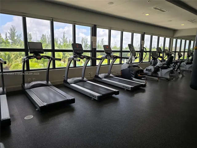 a living room with gym equipment and a large window
