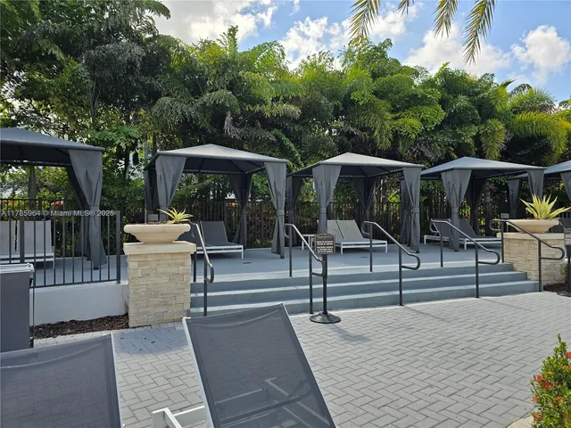 a view of a patio with couches table and chairs and potted plants