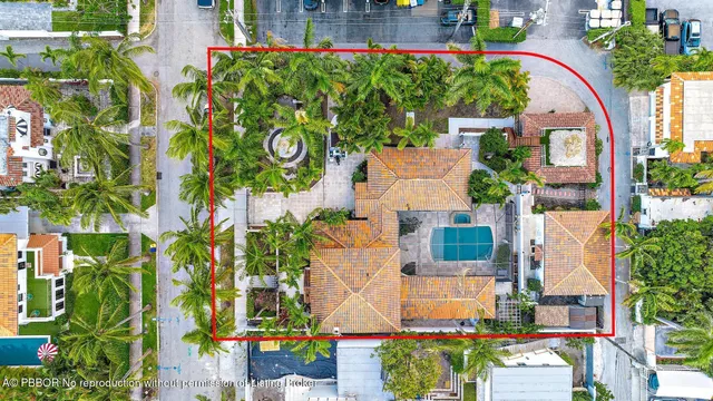 an aerial view of a house with a yard and garden