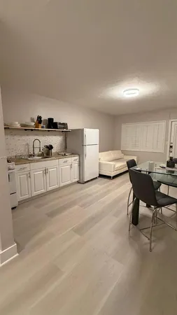 a living room with furniture and kitchen view