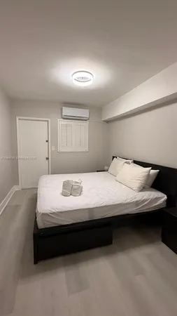 a bedroom with a bed and a night stand