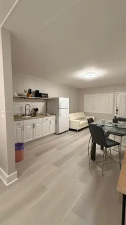a kitchen with stainless steel appliances kitchen island granite countertop a sink and cabinets