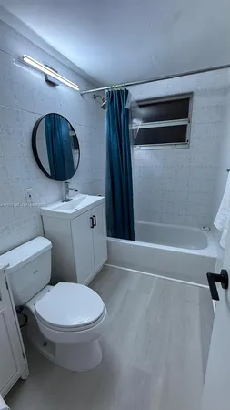 a bathroom with a toilet a sink and bathtub