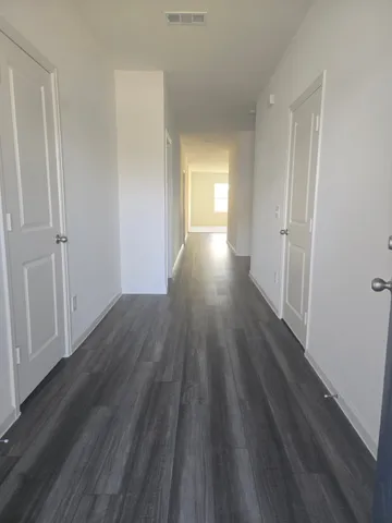 a view of a room with wooden floor and window
