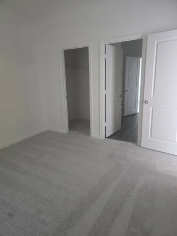 a view of an empty room and closet area