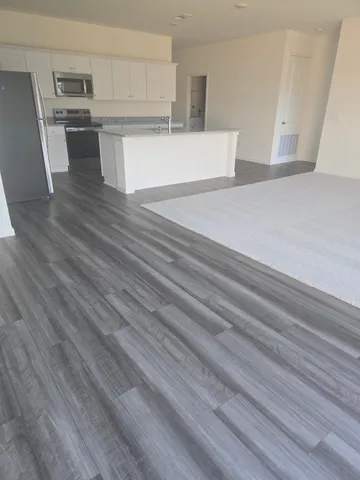 a view of kitchen counter space and wooden floor