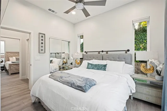 a bedroom with a bed and wooden floor