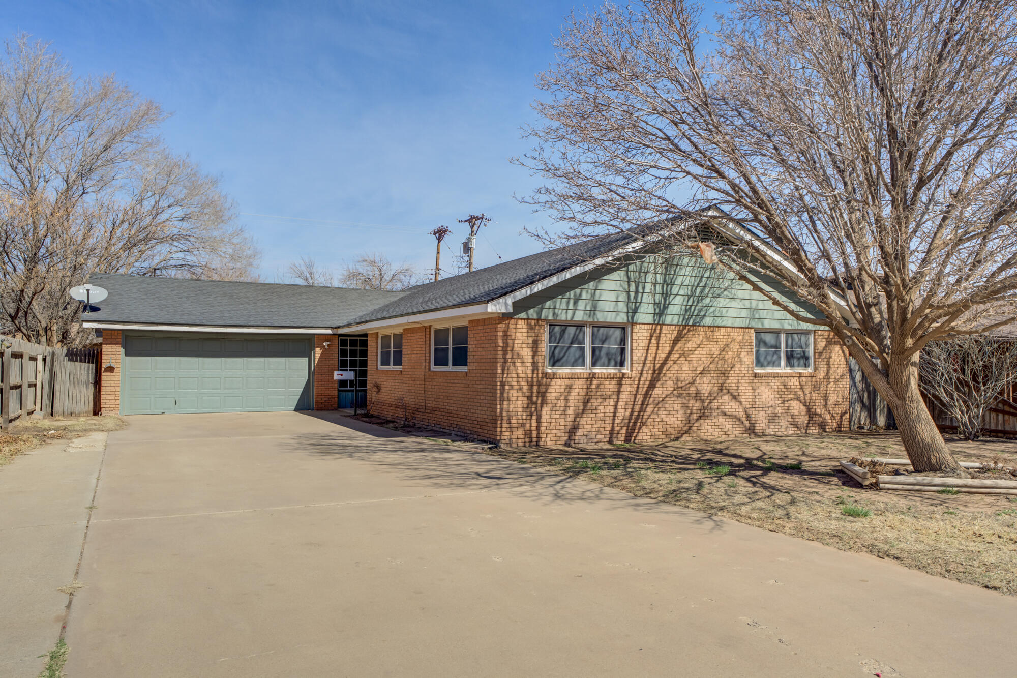 4404 28th Street Lubbock, TX 79410 - Photo 1 of 39 a view of a house with a yard covered in snow