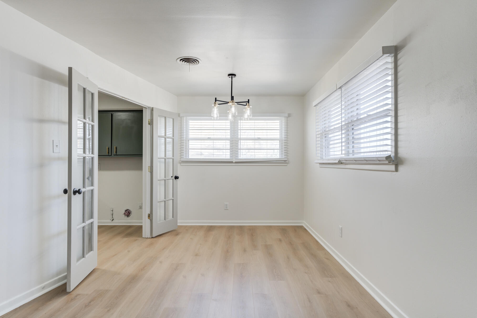 4404 28th Street Lubbock, TX 79410 - Photo 11 of 39 wooden floor in an empty room with a window