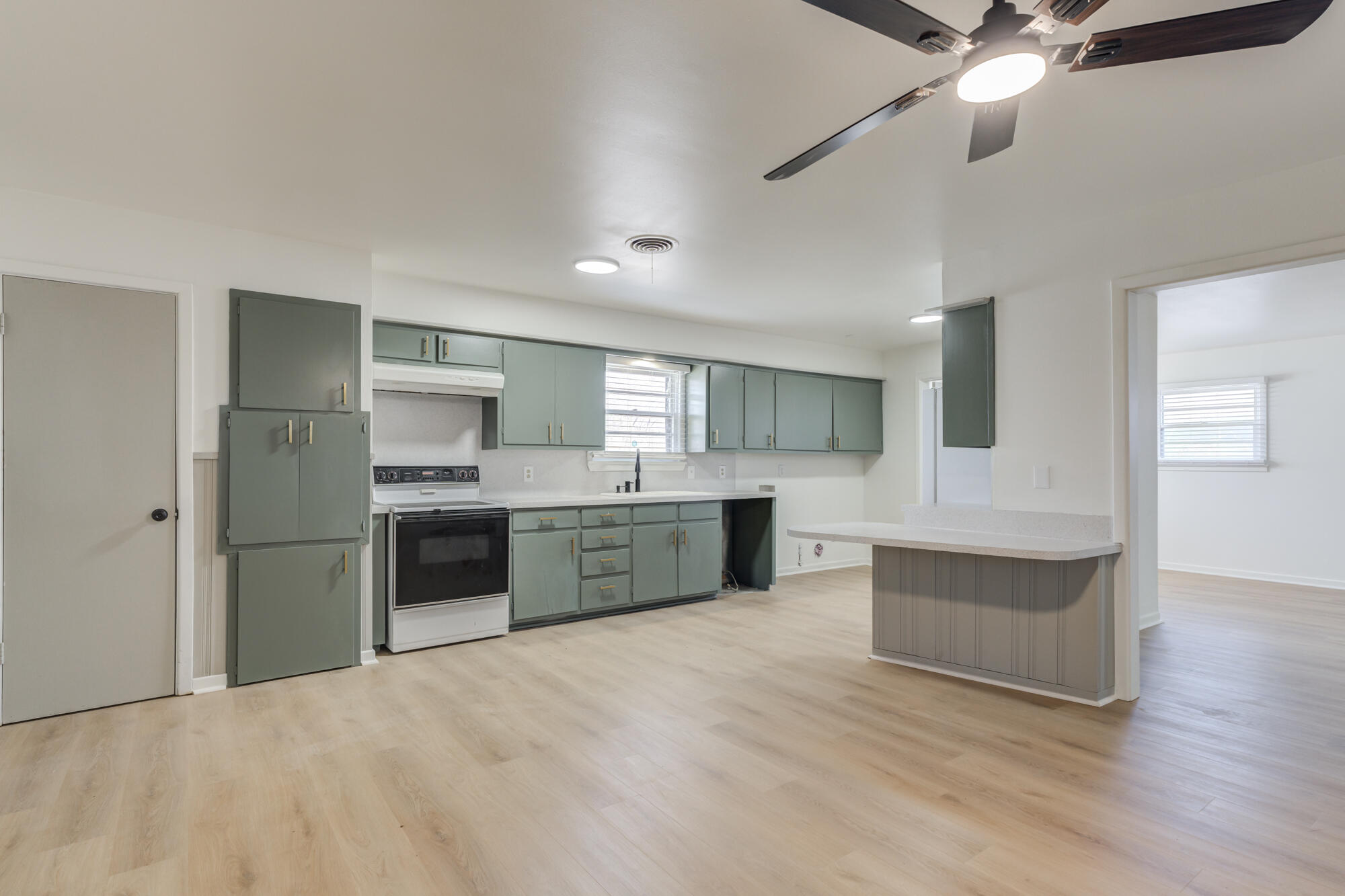 4404 28th Street Lubbock, TX 79410 - Photo 13 of 39 a large kitchen with a refrigerator and a stove top oven