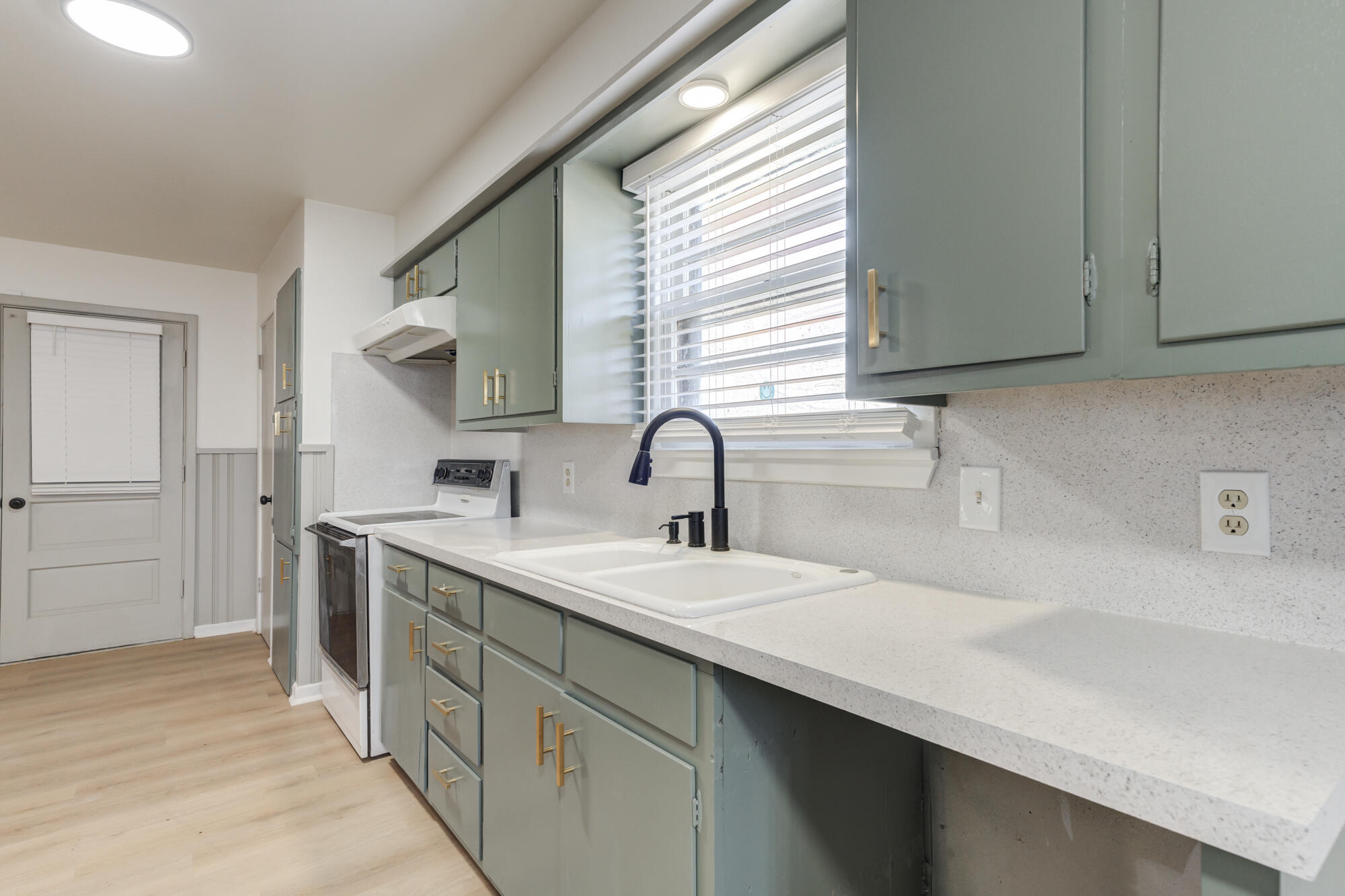 4404 28th Street Lubbock, TX 79410 - Photo 14 of 39 a kitchen with a sink and a window