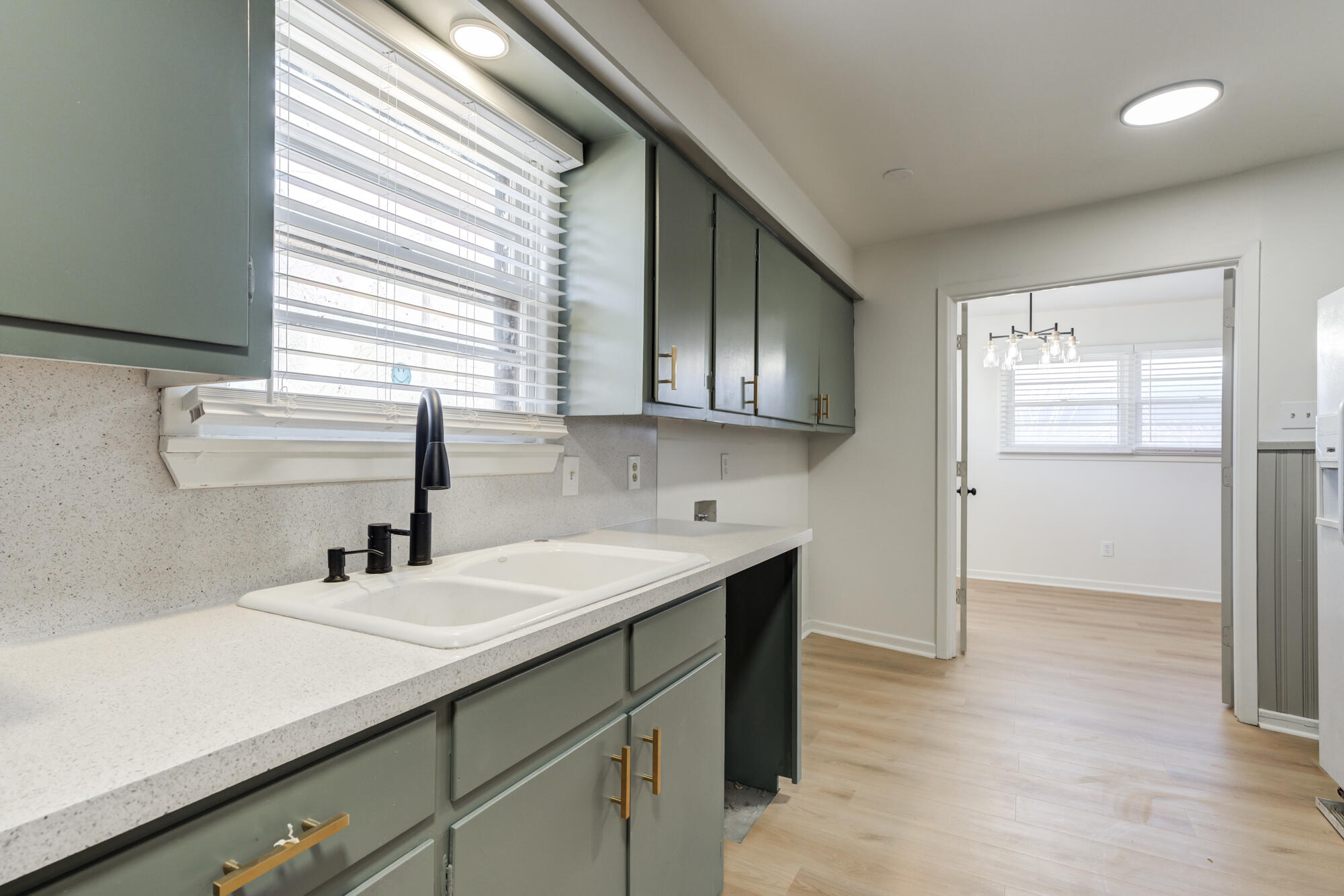 4404 28th Street Lubbock, TX 79410 - Photo 17 of 39 a kitchen with a sink cabinets and a window