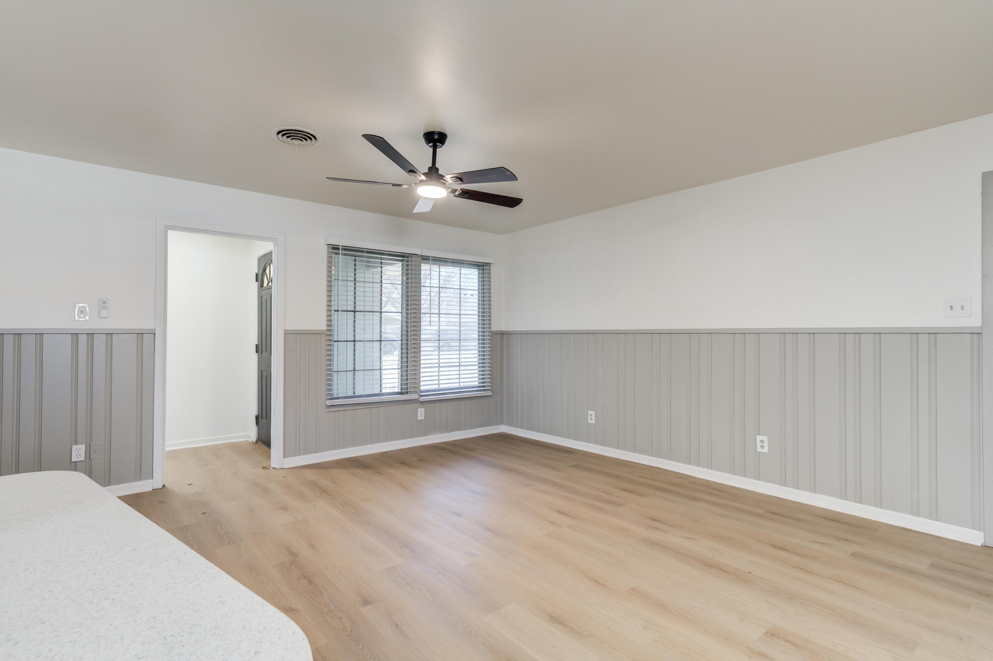 4404 28th Street Lubbock, TX 79410 - Photo 19 of 39 a view of a big room with wooden floor and windows