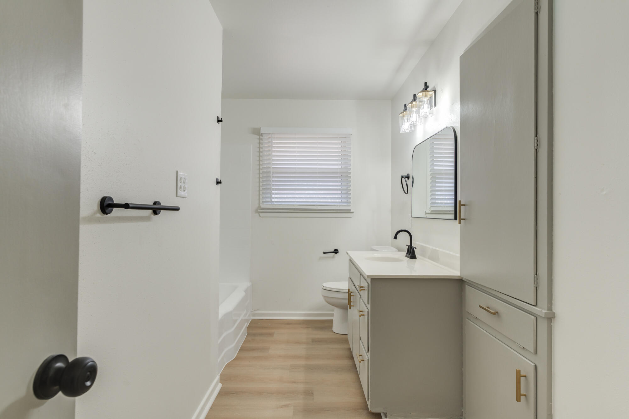 4404 28th Street Lubbock, TX 79410 - Photo 23 of 39 a bathroom with a sink and a mirror
