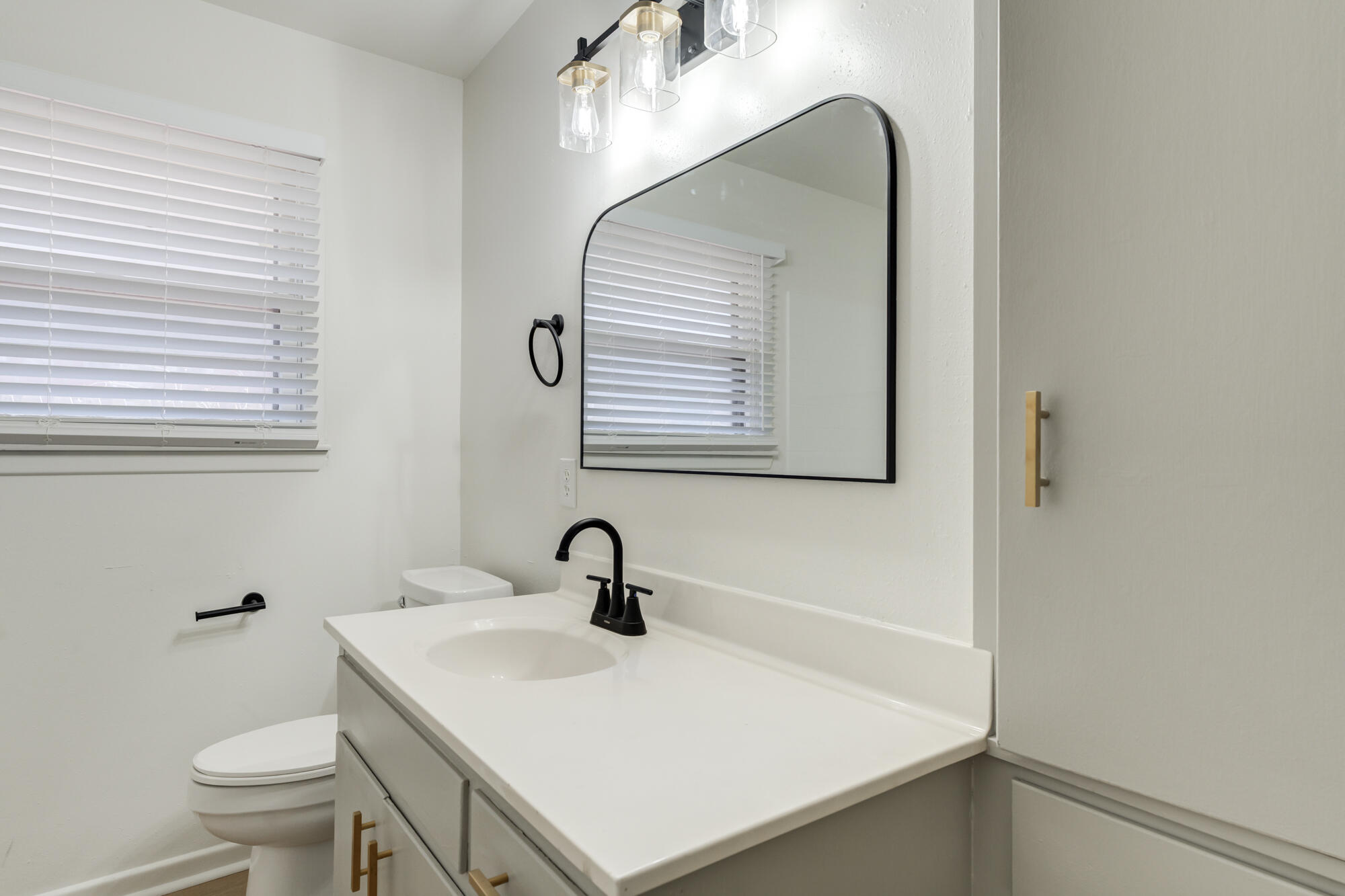 4404 28th Street Lubbock, TX 79410 - Photo 24 of 39 a bathroom with a sink and a mirror