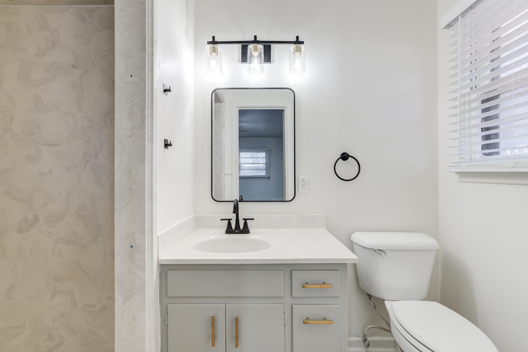 4404 28th Street Lubbock, TX 79410 - Photo 33 of 39 a bathroom with a sink toilet and mirror