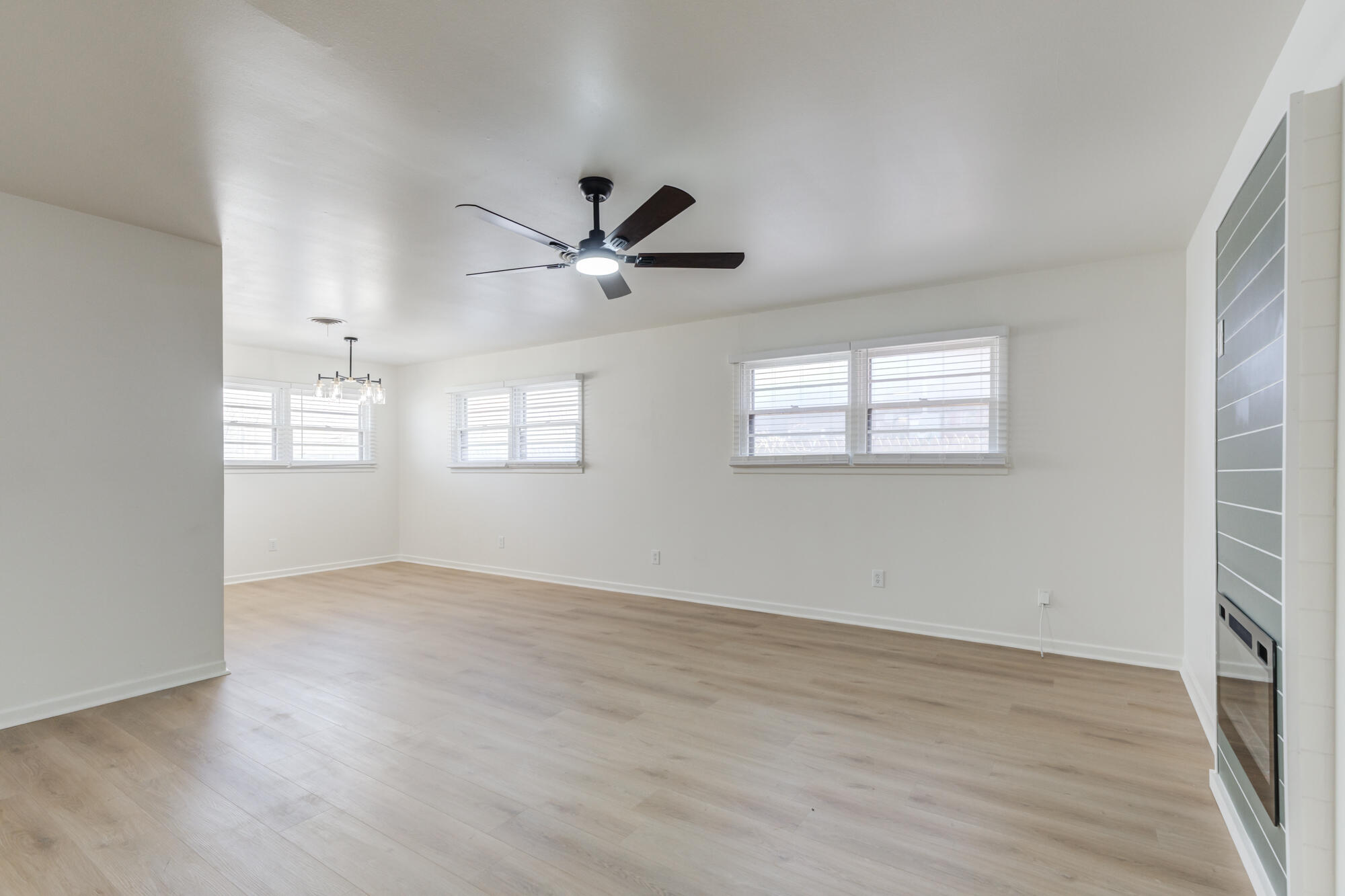 4404 28th Street Lubbock, TX 79410 - Photo 4 of 39 wooden floor in an empty room with a window