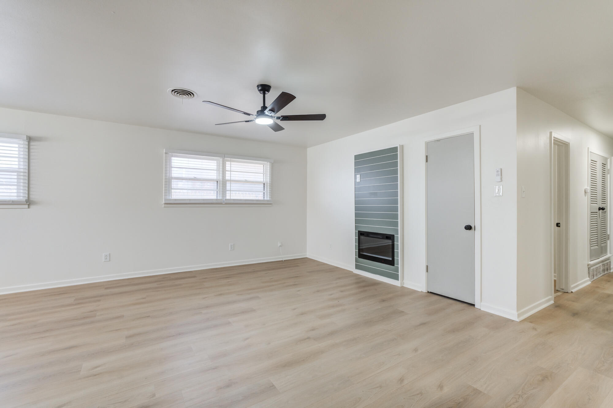 4404 28th Street Lubbock, TX 79410 - Photo 5 of 39 a view of an empty room with a window and a kitchen