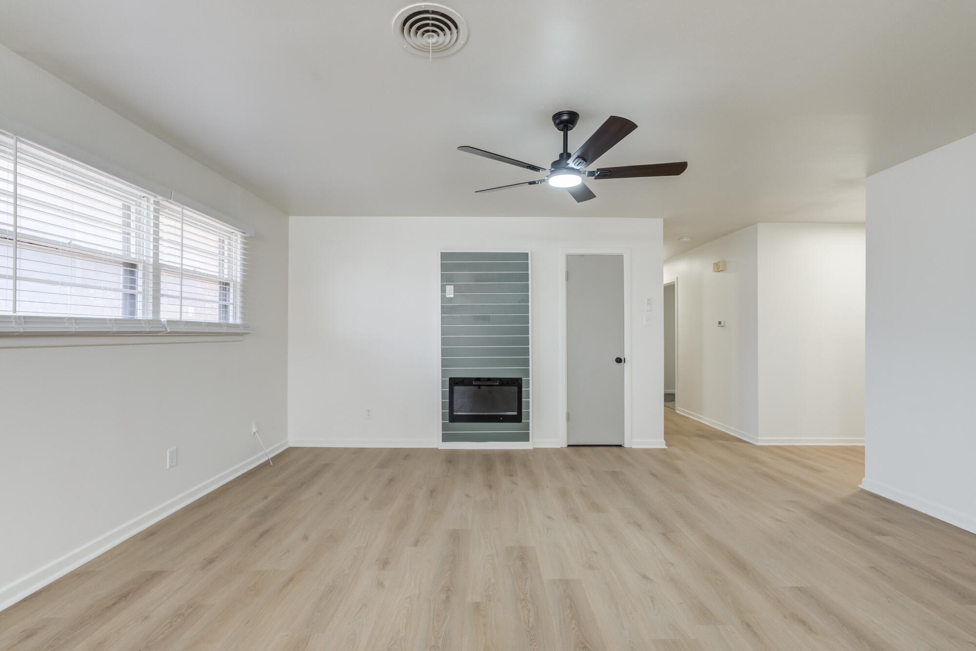 4404 28th Street Lubbock, TX 79410 - Photo 6 of 39 wooden floor in an empty room with a window