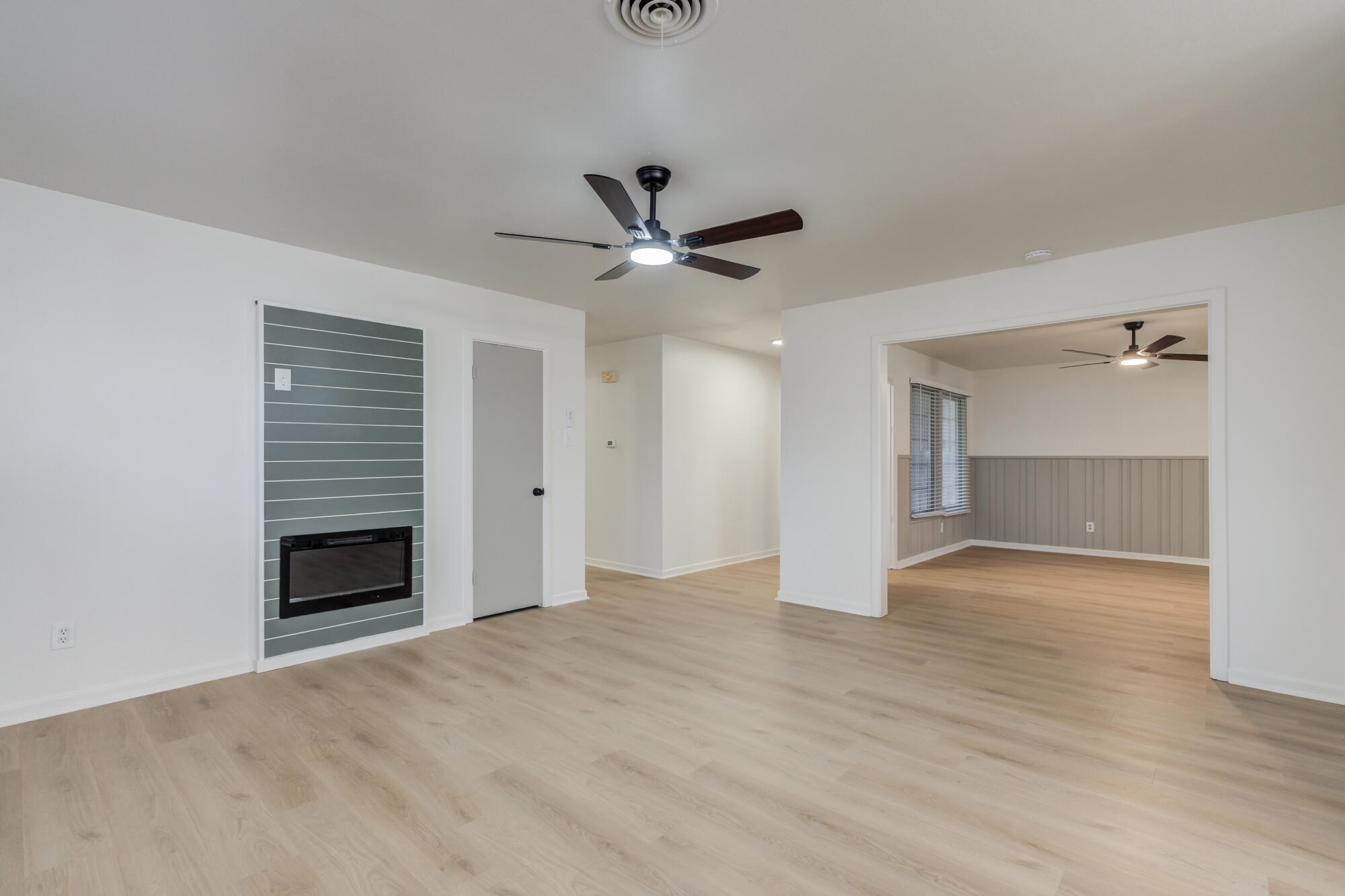 4404 28th Street Lubbock, TX 79410 - Photo 7 of 39 a view of an empty room with a fireplace and a ceiling fan