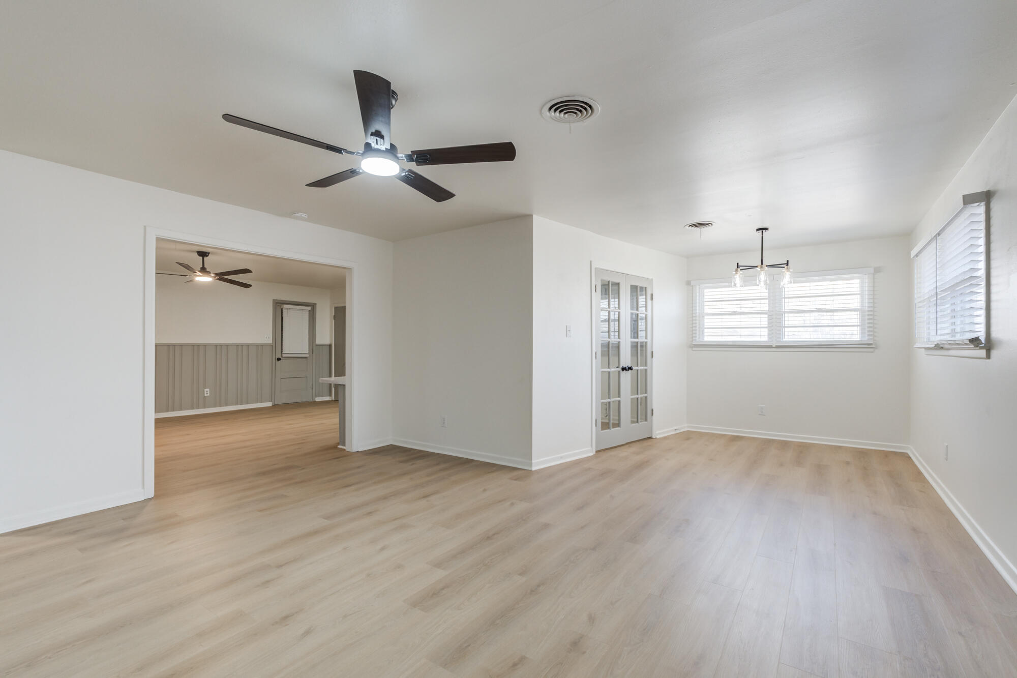 4404 28th Street Lubbock, TX 79410 - Photo 9 of 39 a view of an empty room with a window and wooden floor