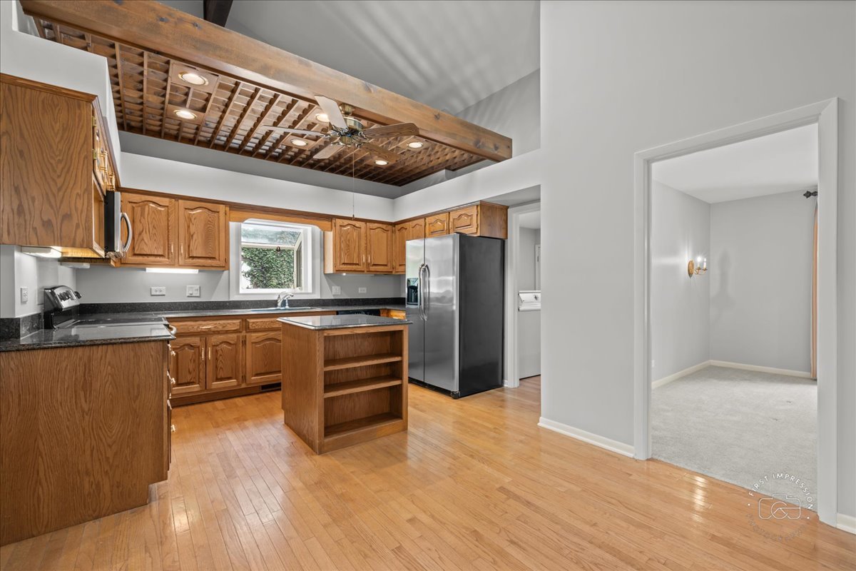 1105 West Bauer Road Naperville, IL 60563 - Photo 13 of 39 a kitchen with stainless steel appliances kitchen island granite countertop a refrigerator and a sink