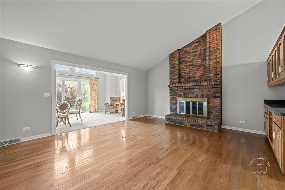 1105 West Bauer Road Naperville, IL 60563 - Photo 17 of 39 a view of an empty room with wooden floor and a window
