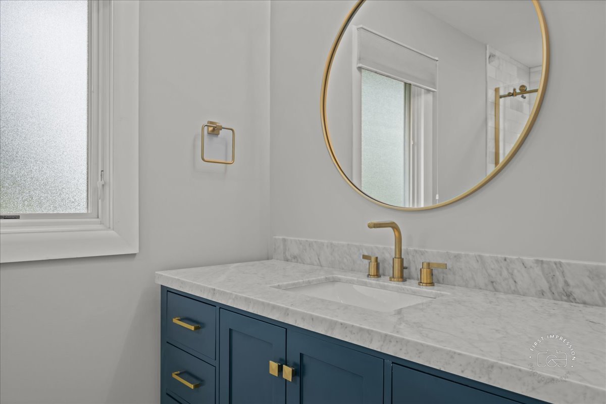1105 West Bauer Road Naperville, IL 60563 - Photo 22 of 39 a bathroom with a granite countertop sink and a mirror