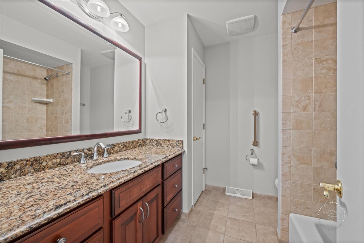1105 West Bauer Road Naperville, IL 60563 - Photo 25 of 39 a bathroom with a granite countertop sink and a mirror