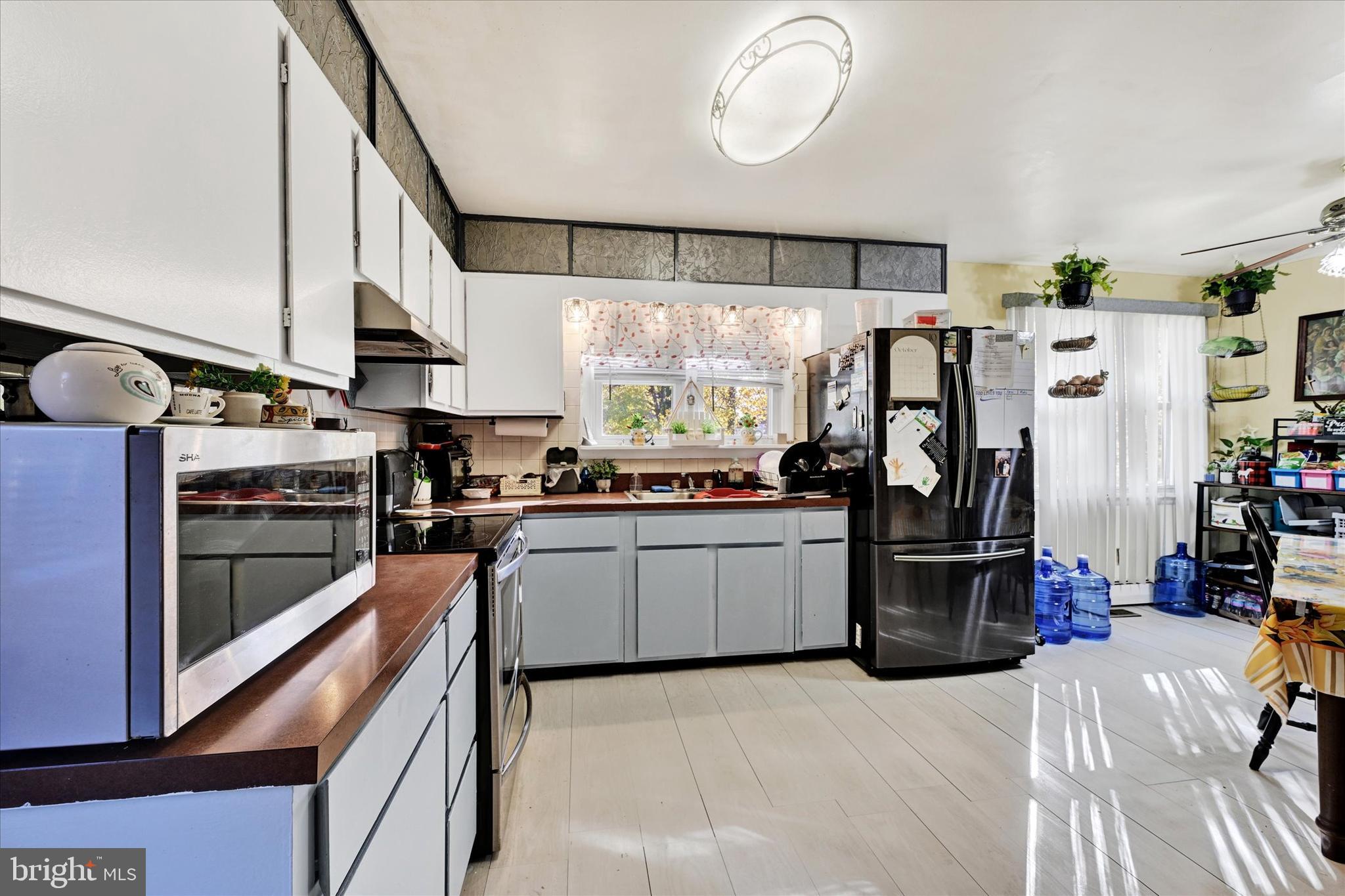1321 Rustic Avenue Baltimore, MD 21237 - Photo 12 of 28 a kitchen with stainless steel appliances kitchen island granite countertop a refrigerator a stove and a sink