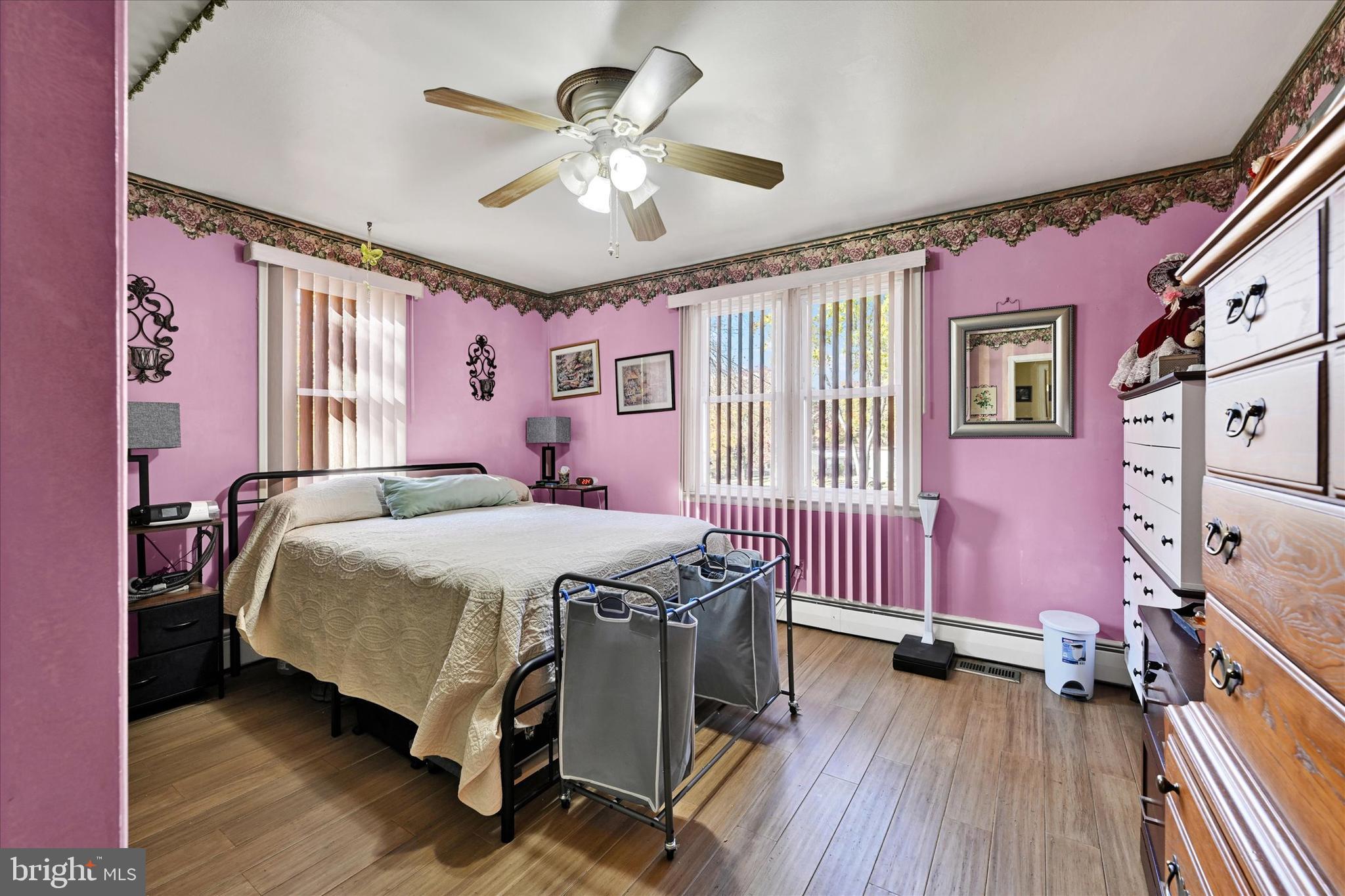 1321 Rustic Avenue Baltimore, MD 21237 - Photo 16 of 28 a bedroom with a bed and wooden floor