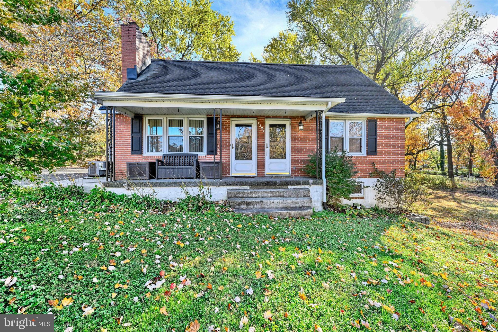 1321 Rustic Avenue Baltimore, MD 21237 - Photo 27 of 28 a front view of a house with a garden and porch