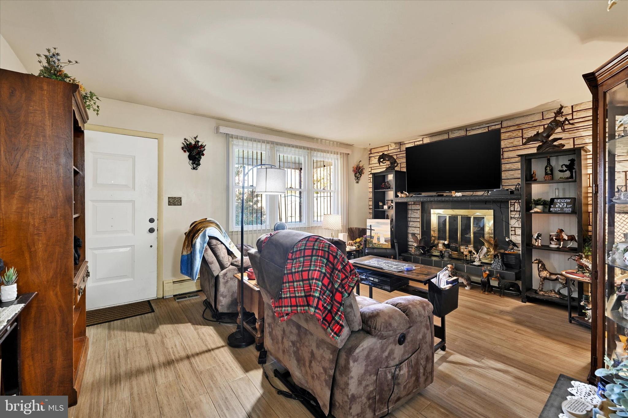 1321 Rustic Avenue Baltimore, MD 21237 - Photo 6 of 28 a living room with furniture a flat screen tv and a refrigerator