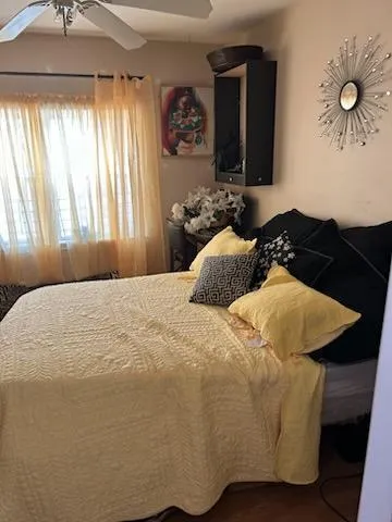 a bedroom with a bed and window