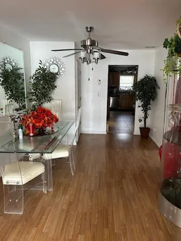 a view of a dining room with furniture and wooden floor