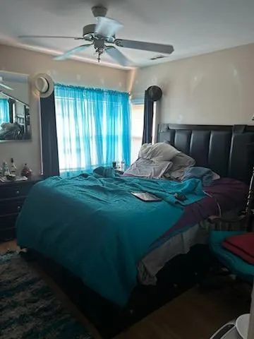 a bed sitting in a bedroom next to a window