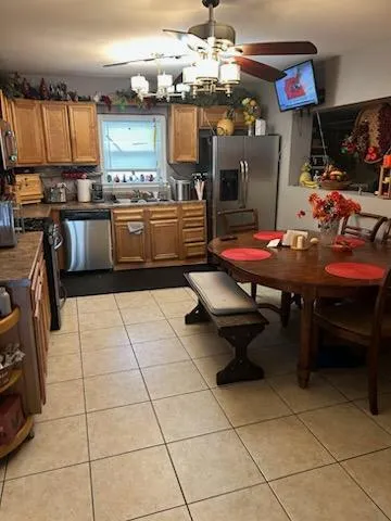 a kitchen with a sink a stove and a refrigerator