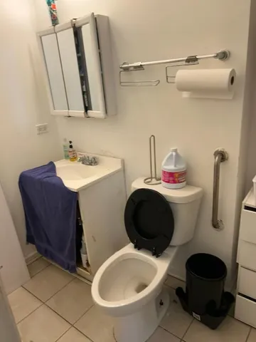 a bathroom with a sink toilet and a mirror