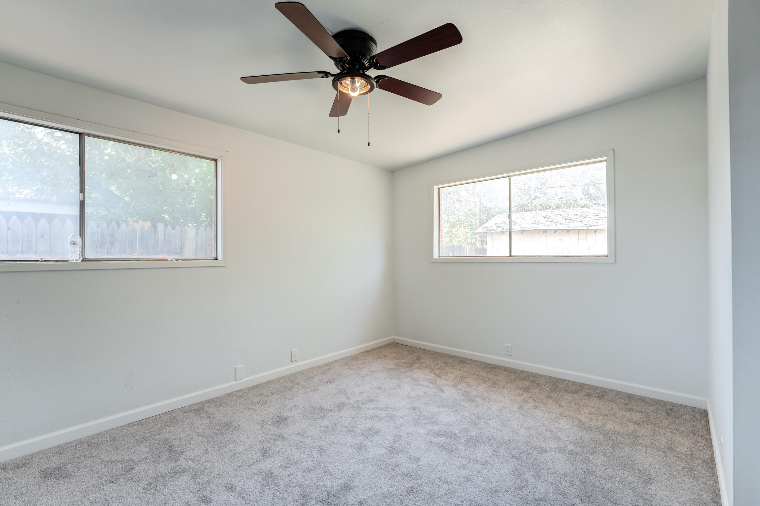 2525 63rd Street Lubbock, TX 79413 - Photo 11 of 14 an empty room with windows and fan