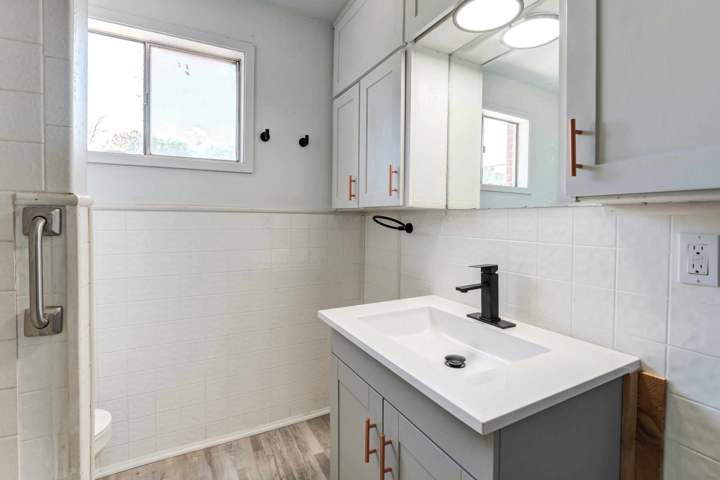 2525 63rd Street Lubbock, TX 79413 - Photo 14 of 14 a bathroom with a sink and a mirror