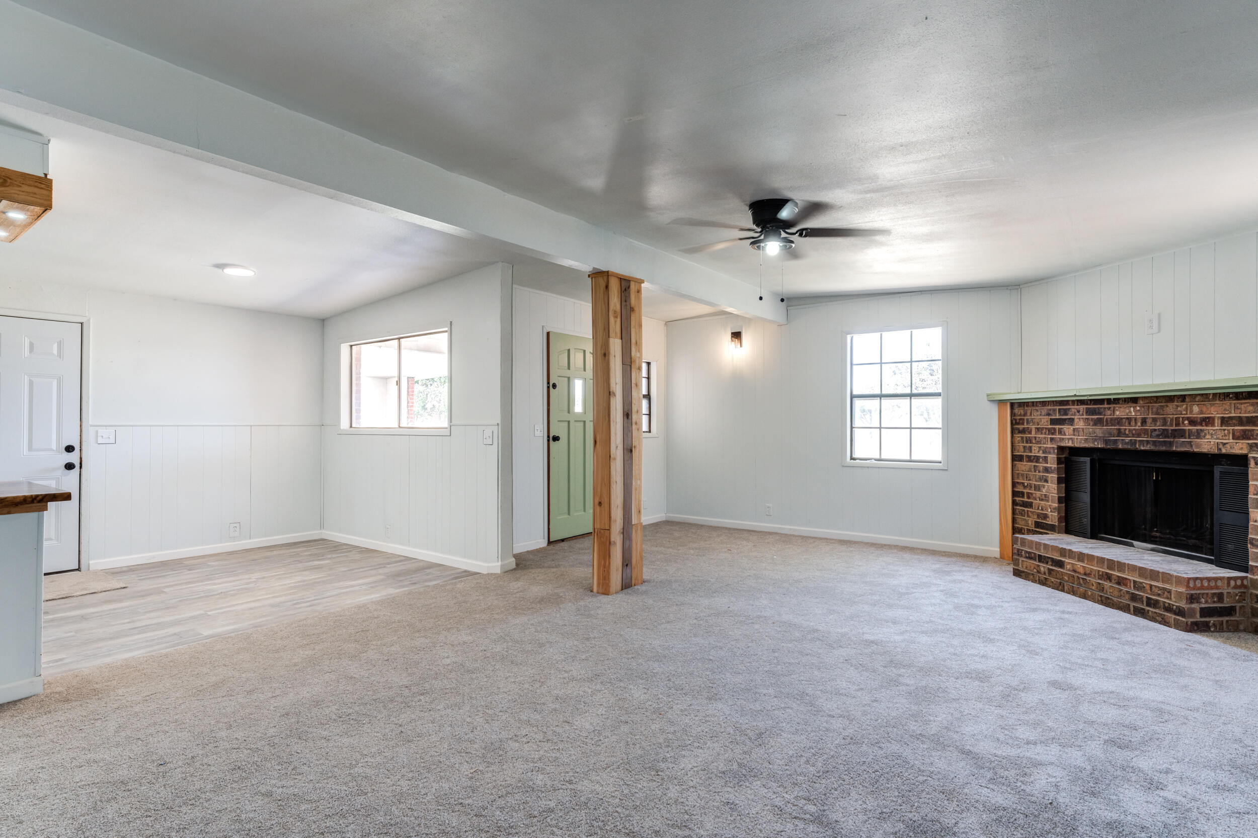 2525 63rd Street Lubbock, TX 79413 - Photo 6 of 14 an empty room with windows and fireplace