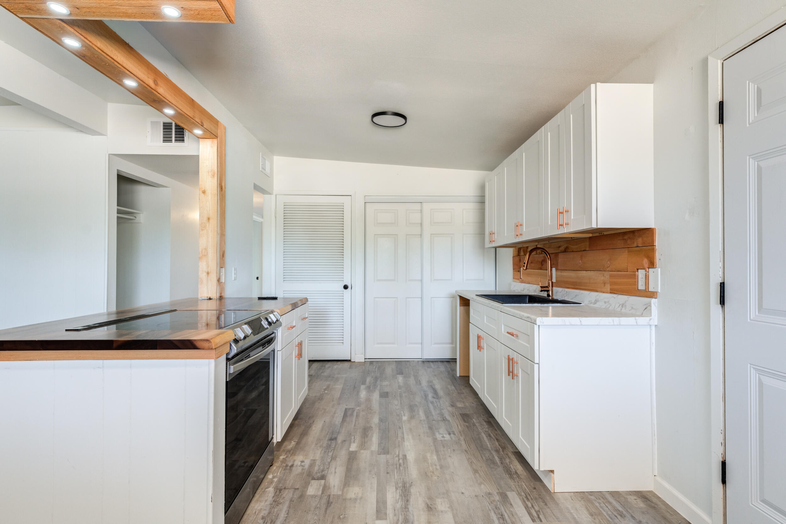 2525 63rd Street Lubbock, TX 79413 - Photo 7 of 14 a kitchen with granite countertop a sink and a stove top oven